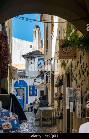 SINTRA, PORTUGAL - 27.. JUNI 2022: Enge Gassen des Dorfes Sintra mit verschiedenen Geschäften, darunter Restaurants und Souvenirs. Stockfoto