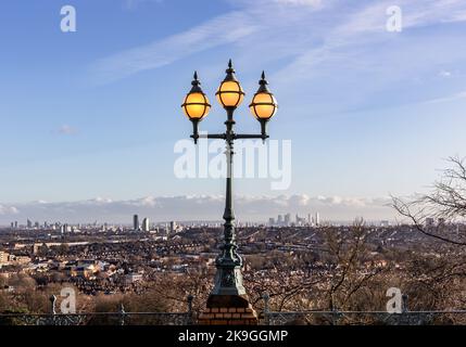 Ein Blick über London von der Spitze des Alexandra Palace.im Vordergrund ist einer der vielen Lampenständer mit filigranem Glas und beleuchtet sogar am Tag. Stockfoto