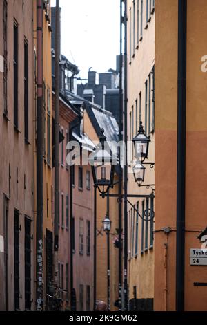 Stockholm, Schweden - 2022. September: Blick auf die farbenfrohe, schmale Altstadtstraße mit Kopfsteinpflasterstraße in Gamla Stan Stockfoto