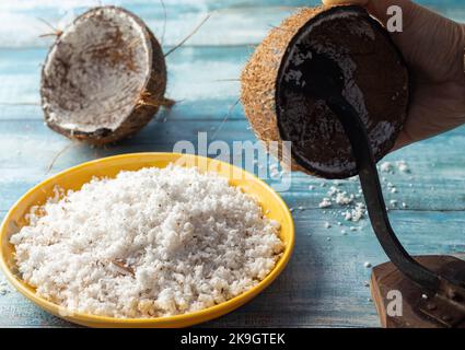 Muscheln und Boden mit Schaber auf einem blauen Holztisch Stockfoto