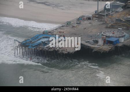 Der Casino Pier von New Jersey in Seaside Heights, NJ, steht gebrochen, und die Star Jet-Achterbahn sitzt jetzt im Meer, wie sie bei einem US-Militärhubschrauber-Flug über die Küste von New Jersey am 1. November 2012 zu sehen war. (USA Armeefoto von Justin ward) Stockfoto