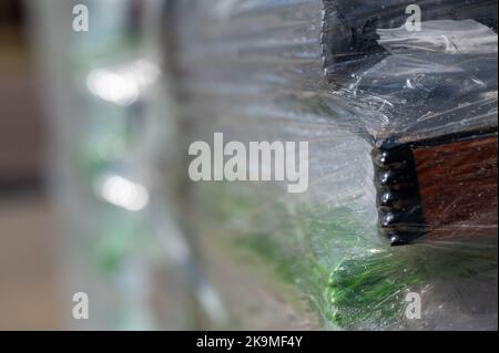 Selektiver Fokus auf Zellophan-Schrumpffolie auf Paletten von Waren für den Transport. Stockfoto