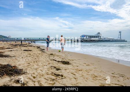 Blick über den Strand von Bournemouth in Dorset, Großbritannien, zum Bournemouth Pier an einem Herbsttag. Stockfoto