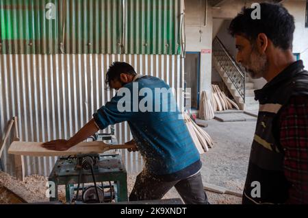 Ein Arbeiter formt Weide auf einer Maschine, um Cricket-Fledermäuse in einer Fabrik in Sangam herzustellen. Seit Jahren gilt Kashmiri-Weide als dem Holz der englischen Weide, die immer noch ein nahezu Monopol über die globale Cricket-Fledermaus-Industrie besitzt, erheblich unterlegen und hat vor kurzem einen bedeutenden Ausflug in die internationale Cricket-Welt unternommen, der von einigen Spielern bei der Weltmeisterschaft T20 und der verwendet wurde Legends Cricket League. In den letzten vier Jahren haben 25 Geschäftseinheiten der Fledermausherstellungsindustrie in Halmulla und Sangam im Bijbehara-Gürtel aufgrund mangelnder Nachfrage geschlossen. Stockfoto