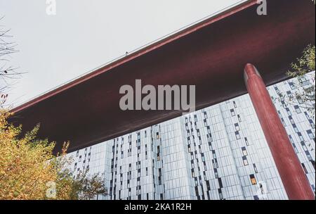 Niedriger Blick auf die Brücke gegen ein modernes Gebäude Stockfoto