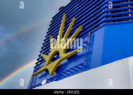 Southampton, England P&O Ferry Iona Luxus-Kreuzfahrt-Schiff dockte im Hafen mit Regenbogen hinter Schornstein und P und O-Logo goldenen Sonnenaufgang Symbol. Stockfoto