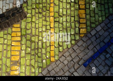 Kleine Fliesen. Mosaik an der Wand. Bild von Scherben. Mosaikwandstruktur. Stockfoto