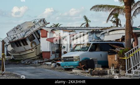 Fort Myers Beach, Usa. 30. Oktober 2022. Ein Boot und ein beschädigtes Fahrzeug werden unter Anhängern in einem Mobilhome-Park in Fort Myers Beach, Florida, einen Monat nach Hurrikan Ian, der am 28. September als Hurrikan der Kategorie 4 landet, gesehen. Verursacht geschätzte $67 Milliarden an versicherten Schäden und mindestens 127 stürmbedingte Todesfälle in Florida. (Foto von Paul Hennessy/SOPA Images/Sipa USA) Quelle: SIPA USA/Alamy Live News Stockfoto