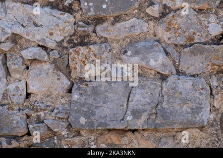 Detaillierte strukturierte Hintergrund von Sandstein alten Wand mit Blöcken hellgelb gefärbt Stockfoto