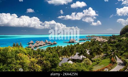 Eine Luftaufnahme des Conrad Bora Bora Nui Hotels mit Überwasser-Bungalows unter einem blau bewölkten Himmel Stockfoto