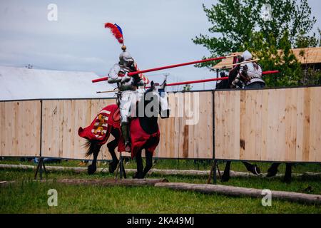 Ritter auf Pferden in einem Springturnier Stockfoto