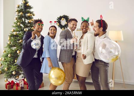 Gruppe von fröhlichen jungen multirassischen Freunden tanzen und Spaß an der Weihnachtsfeier Stockfoto