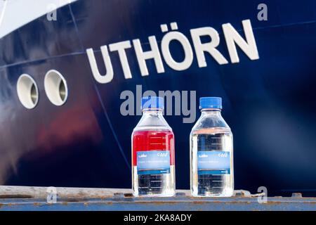 Bern, Deutschland. 01.. November 2022. Vor dem Schiff stehen Flaschen mit herkömmlichem Dieselkraftstoff (l) und dem Methanol-Kraftstoff, der im neuen Forschungsschiff 'Uthörn' verwendet wird. Der neue 'Uthörn' ersetzt den 1982 in Auftrag gegebenen Forschungsschneider gleichen Namens. Der Neubau soll das erste Seeschiff der Welt sein, das mit umweltfreundlichem und nachhaltigem Methanol betrieben wird und vom Alfred-Wegener-Institut (AWI) genutzt wird. Quelle: Sina Schuldt/dpa/Alamy Live News Stockfoto