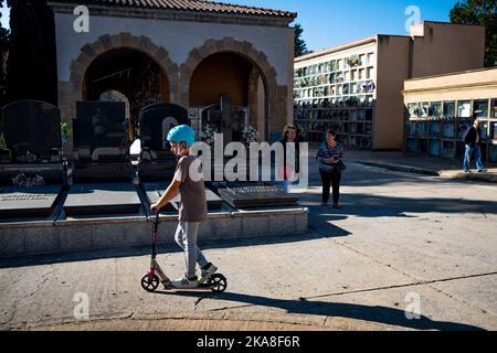 Barcelona, Spanien. 01.. November 2022. Ein Kind hat gesehen, wie es einen Roller auf dem Friedhof von Sant Andreu fuhr. Allerheiligen, ein christlich-katholisches Fest, das auch als Allerheiligen-Fest bekannt ist, ist es in Spanien und Europa Tradition, am 1.. November Friedhöfe und Gräber von Verstorbenen zu besuchen, um den Angehörigen Respekt zu zollen, da All Souls Day, auch bekannt als Tag der Toten, Ist in der Regel kein Nationalfeiertag. Kredit: SOPA Images Limited/Alamy Live Nachrichten Stockfoto