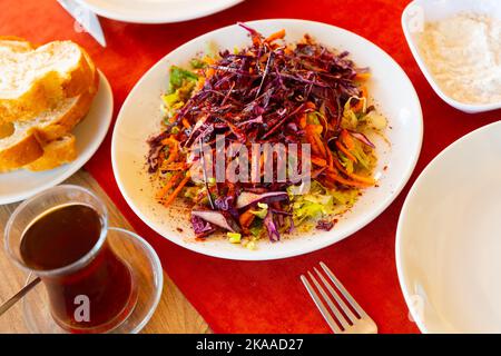 Traditioneller türkischer Salat aus geschreddertem Kohl und Karotten mit Olivenöl und Sumac Stockfoto