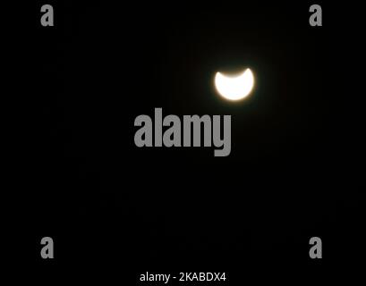 Partielle Sonnenfinsternis, die am Dienstag, dem 25. Oktober, auftrat, konnte in vielen Bereichen beobachtet werden Stockfoto