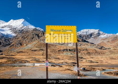 Schild mit Hinweis auf eine Wasserscheide in den Alpen, wo links das Wasser zur Adria und rechts zum Schwarzen Meer fließt. Stockfoto