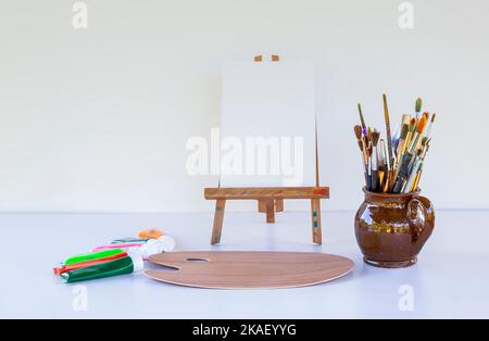 Arbeitsplatz des Künstlers. Leinwand, Farben, Pinsel und Palette. Stockfoto