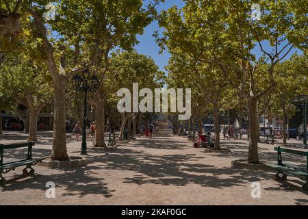 Saint-Tropez, Frankreich - 8. August 2022 - der landschaftlich reizvolle Place des Lices - auf dem Platz befindet sich sowohl ein provenzalischer Markt als auch ein Spielplatz für Boccia-Spieler Stockfoto