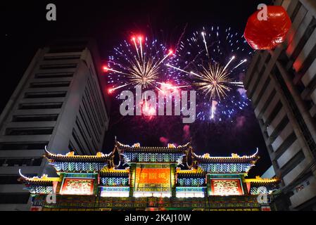 Ein Feuerwerk erleuchtet den Himmel über dem Chinatown-Freundschaftsbogen, dem größten der Welt, der sich am Vorabend des chinesischen Neujahrs am 07. Februar 2016 im Stadtteil Binondo in Manila befindet. Philippinisch-chinesische Bürger begrüßen das chinesische Mondneujahr, das auf den 08. Februar fällt und den Beginn des Jahres des Feueraffen markiert. Stockfoto