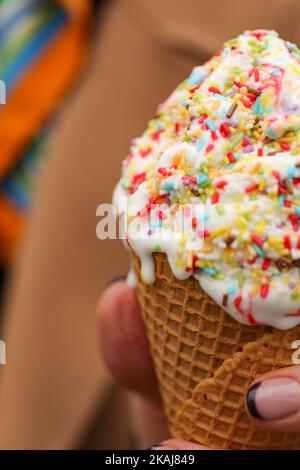 Ein Vanilleeis mit Waffeln mit bunten Krümeln, Nahaufnahme, vertikal Stockfoto