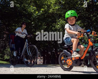 Eine Frau und ein Junge fahren am 24. Mai 2017 mit dem Fahrrad durch eine Straße in Brügge, Belgien. An einem der wärmsten Tage des Jahres wurde Brügge von Tausenden von Touristen aus der ganzen Welt ausgewählt. Dies ist die Hauptstadt und größte Stadt der Provinz Westflandern in der flämischen Region Belgiens, im Nordwesten des Landes. Da Brügge ein riesiges Touristenziel ist, haben Touristen eine große Auswahl, um die Stadt zu genießen, wie Pferdekutschenfahrten, Grachtenfahrten mit dem Boot oder einfach nur einen Spaziergang durch das historische Stadtzentrum. (Foto von Romy Arroyo Fernandez/NurPhoto) *** Bitte an uns Stockfoto