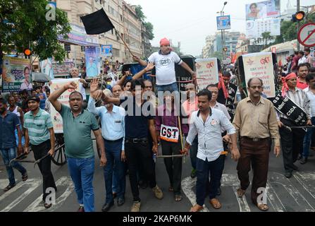 Tuchhändler und -Arbeiter rufen Slogans und ziehen die Rickshaw in Burrabazar während des Streiks gegen GST in Kalkutta, Indien, am Mittwoch, 12.. Juli 2017.Tuchhändler gehen Anfang Juni 27 landesweit streiken, um gegen 5 Prozent der GST (Waren- und Dienstleistungssteuer) zu protestieren, die auf die Dienstleistungen erhoben wurden (Arbeit) von ihnen für die Textilindustrie geleistet. Textilhändler protestieren im ganzen Land gegen ‘komplexe, verwirrende’ GST-Regeln (Waren- und Dienstleistungssteuer). (Foto von Sonali Pal Chaudhury/NurPhoto) *** Bitte nutzen Sie die Gutschrift aus dem Kreditfeld *** Stockfoto