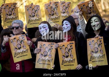 Aktivisten bedecken ihre Gesichter bei Demonstrationen mit den Guy Fawkes-Masken. Aktivisten der Unabhängigkeitsbefürworter hängen in den Straßen von Barcelona, Spanien, Plakate zur Unterstützung der katalanischen politischen Gefangenen und der nach der Unabhängigkeitserklärung Kataloniens am 5. November 2017 in Belgien verbannten Präsidentin Carles Puigdemont (Foto: Miquel Llop/NurPhoto) Stockfoto