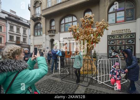 Peopel fotografieren vor dem weihnachtlichen Diduch, einem weihnachtlichen Ornament aus einer Weizenschnur, einem symbolischen Opfer aus dem Besten der Herbsternte und dem wichtigsten Weihnachtssymbol, das am orthodoxen Weihnachtstag auf dem Yavorsky-Platz in der Altstadt von Lemberg zu sehen ist. Am Sonntag, den 7. Januar 2018, in Lemberg, Ukraine. (Foto von Artur Widak/NurPhoto) Stockfoto