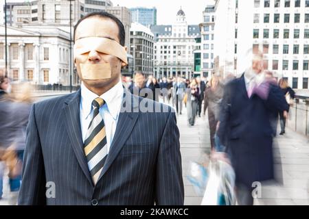 London Professionals, Business Ignoranz. Ein schkelter Stadtarbeiter mit seinen Sinnen, die von seiner urbanen Welt eingeschränkt sind. Aus einer Reihe verwandter Bilder. Stockfoto