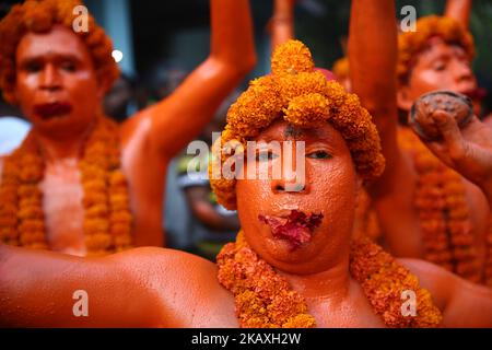 Hinduistische Anhänger tanzen am 13. April 2018 am letzten Tag des bangladeschischen Monats in Munshigonj, Dhaka, Bangladesch, während sie an einem Festival namens Lal Kach (Rotes Glas) teilnehmen.das Lal Kach Festival ist seit mehr als hundert Jahren für die lokale Gemeinschaft bekannt. Die hinduistischen Jugendlichen und Männer malen sich rot an und nehmen an einer Prozession mit Schwertern Teil, während sie Macht gegen das Böse zeigen und das bengalische Neujahr 1425 am 14. April 2018 begrüßen (Foto: Mushfiqul Alam/NurPhoto) Stockfoto