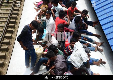 Menschen, die in Bangladesch leben, fahren auf dem Dach eines Zuges, während sie am 19. August 2018 in ihr Zuhause zurückkehren, um das Eid-Al-Adha-Festival in Dhaka, Bangladesch, zu feiern. Tausende von Dhaka-Stadtbewohnern begannen, die Stadt in die Heimatstadt zu verlassen, um das Eid-al-Adha-Festival zu feiern. (Foto von Mamunur Rashid/NurPhoto) Stockfoto