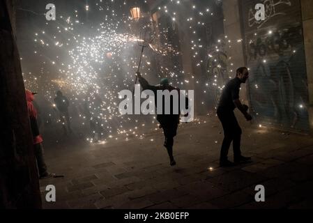 Während der Feier des Sant Roc Festivals in Barcelona (Spanien) am 18. August 2018 läuft ein Teufel inmitten der Pyrotechnik. Correfocs, eine alte katalanische Tradition, in der Menschen, die als Teufel verkleidet sind, Feuerwerkskörper und Fackeln in die Luft sprengen, nehmen jeden August an den Feierlichkeiten zum Sant Roc Festival im gotischen Viertel von Barcelona Teil. (Foto von Jordi Boixareu/NurPhoto) Stockfoto