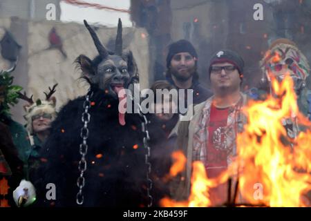 Menschen in Kostümen versammeln sich am 15. Dezember 2018 während der acht jährlichen Parade der Spirits Krampus durch das Viertel Northern Liberties in Philadelphia, PA, um ein Lagerfeuer. Krampus stammt aus europäischen Traditionen wie dem umstrittenen Zwarte Piet (Schwarzer Pete) aus den Niederlanden und ähnlichen Charakteren, die in der Folklore verschiedener europäischer Kulturen missverhandelte Kinder nachgehen. (Foto von Bastiaan Slabbers/NurPhoto) Stockfoto