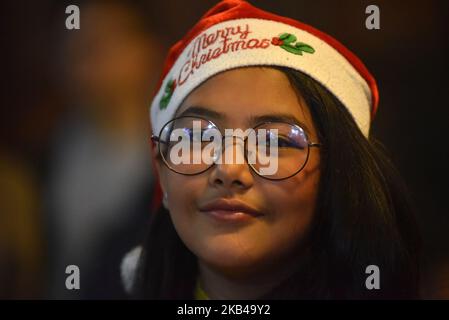 Ein Porträt von Eva George, 12rs, posiert für das Foto mit dem Weihnachtshut auf ihrem Kopf während der HEILIGABEND-Feier in der Katholischen Himmelfahrtskirche in Dhobighat, Lalitpur, Nepal am Montag, 24. Dezember 2018. (Foto von Narayan Maharjan/NurPhoto) Stockfoto