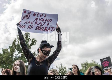 Eine Frau, die eine Katzenmaske trägt, hält während eines Tierrechtsmarsches in Kiew am 15. September 2019 ein Plakat mit der Aufschrift „'Meow, streichelt mich, aber beleidigt mich nicht“. (Foto von Oleksandr Rupeta/NurPhoto) Stockfoto