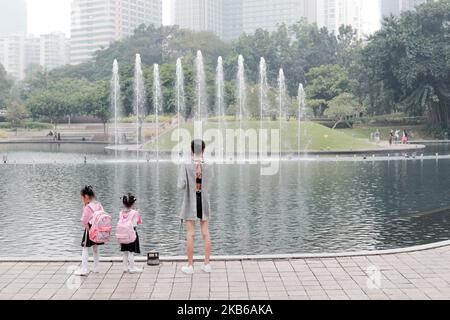 Touristen schauen sich am 19. September 2019 in Kuala Lumpur, Malaysia, den KLCC-Park an, mit einem schweren Dunst. Waldbrände in Indonesien führten dazu, dass Teile Sumatras mit Dunst bedeckt wurden, einschließlich Malaysia und Singapur. Die malaysische Regierung sagte heute, dass sie den Druck auf ihre südostasiatischen Nachbarn erhöhen wird, eine Lösung für die wiederkehrenden Ausbrüche von smog-drückenden Waldbränden in Indonesien zu finden, da die Luftqualität sank und mehr Schulen geschlossen wurden. (Foto von Chris Jung/NurPhoto) Stockfoto