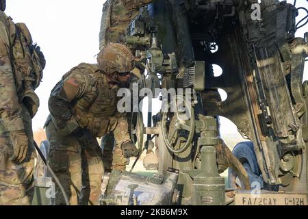 Ein US-Soldat, der Bravo Battery, Field Artillery Squadron, 2. Cavalry Regiment, zugewiesen wurde, richtet eine M777 geschleppte 155mm Haubitze auf eine Zielkoordinate aus, während einer Live-Feuerübung auf dem Trainingsgelände des 7. Army Training Command in Grafenwoehr, Deutschland, 27. Oktober 2022. 2CR stellt V Corps eine tödliche und agile Kraft zur Verfügung, die in der Lage ist, schnell im gesamten europäischen Theater zu stationieren, um Verbündete zu versichern, Gegner abzuschrecken und, wenn befohlen, das NATO-Bündnis zu verteidigen. (USA Armee-Foto von SPC. Ryan Parr) Stockfoto