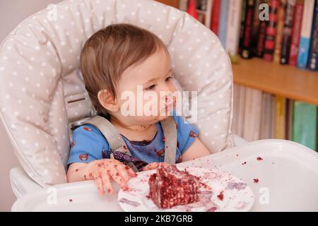 Erste Geburtstagsfeier und zum ersten Mal essen Kuchen für diesen kleinen Jungen Stockfoto