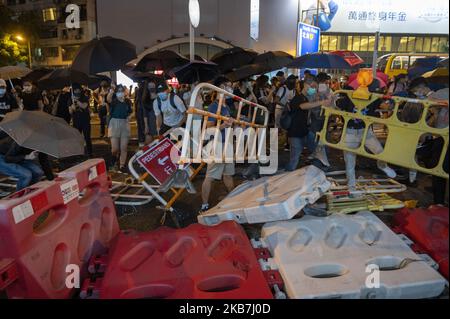 Demonstranten sehen sich bewegende Barrikaden in Hongkong am 4. Oktober 2019 rief Hongkong zum ersten Mal seit mehr als einem halben Jahrhundert Nothilfebefugnisse auf, um nach monatelangen Unruhen Gesichtsmasken für Demonstranten zu verbieten. Die Demonstranten wurden aufgefordert, Straßen in der Innenstadt zu besetzen und den U-Bahnbetreiber dazu zu zwingen, alle Dienste am späten Freitag stillzulegen. (Foto von Vernon Yuen/NurPhoto) Stockfoto