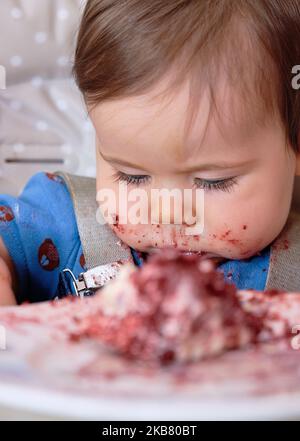 Erste Geburtstagsfeier und zum ersten Mal essen Kuchen für diesen kleinen Jungen Stockfoto