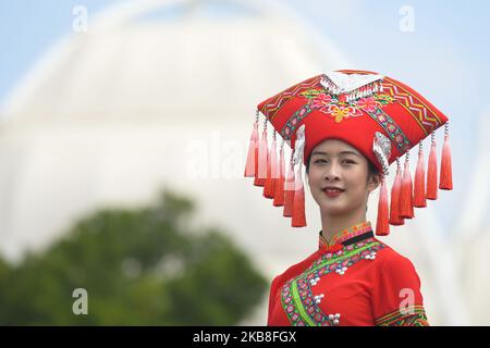 Ein Mädchen auf dem Podium, das ein traditionelles Volkstracht in der Region Guangxi trägt, das im Startbereich kurz vor dem Start der Eröffnungsphase, der 135,6km Beihai Stage, der 3. Cycling Tour de Guangxi 2019, zu sehen ist. Am Donnerstag, den 17. Oktober 2019, China. (Foto von Artur Widak/NurPhoto) Stockfoto