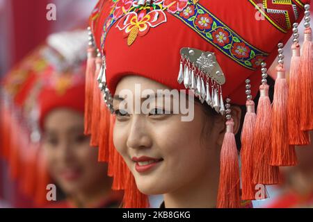 Podium-Mädchen tragen ein traditionelles Volkstracht in der Region Guangxi, gesehen im Startbereich kurz vor dem Start zur Eröffnungsphase, 135,6km Beihai Stage, der 3. Cycling Tour de Guangxi 2019, . Am Donnerstag, den 17. Oktober 2019, China. (Foto von Artur Widak/NurPhoto) Stockfoto