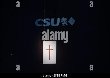 Ein Kreuz hängt unter dem CSU-Logo auf dem Parteitag der Christlich-Sozialen Union am 19. Oktober 2019 in der Münchner Olympiahalle. Die Partei wird einen neuen Vorstand wählen. (Foto von Alexander Pohl/NurPhoto) Stockfoto