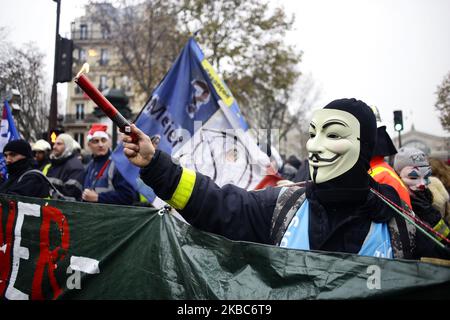 Ein maskierter Protestler demonstriert und ruft Parolen während eines Massenstreiks gegen Rentenreformen am 05. Dezember 2019 in Paris, Frankreich. Züge abgesagt, Schulen geschlossen: Frankreich hat sich beeilt, Notfallpläne für einen massiven Streik gegen Pensionsüberholungen zu erstellen, was eine der größten Herausforderungen für die weitreichende Reformbestrebungen des französischen Präsidenten darstellt. (Foto von Ibrahim Ezzat/NurPhoto) Stockfoto