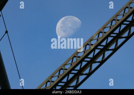 Der Mond durch die Williamsburg Bridge, eine Hängebrücke in New York City über den East River, die Lower East Manhattan mit dem Williamsburg-Viertel in Brooklyn am Broadway verbindet. Die erhellende Luna, der natürliche Erdsatellit im Orbit, wie man sie in der schwindenden Gibbous-Mondkalenderphase mit 76 % Sichtbarmachung sieht. NYC, USA - 17. November 2019 (Foto von Nicolas Economou/NurPhoto) Stockfoto