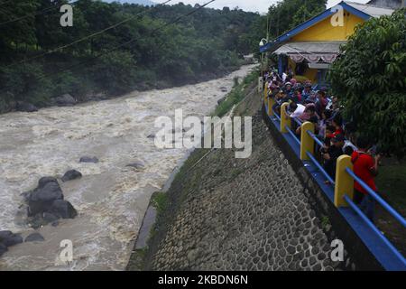 Am 1. Januar 2020 beobachteten mehrere Menschen den Anstieg des Wasserpegels des Ciliwung-Flusses im Katulampa-Staudamm in Bogor, West-Java. Starke Regenfälle, die die Region Bogor seit Dienstag (31. Dezember 2019) durchspülten, verursachten einen Anstieg des Wasserpegels im Katulampa-Staudamm und die Auswirkungen der Überschwemmungen in Jakarta. Nach Angaben der National Disaster Management Agency (BNPB) starben in Jakarta 9 Menschen und 19.709 Menschen wurden durch Überschwemmungen vertrieben. (Foto von Adriana Adie/NurPhoto) Stockfoto