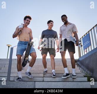 Freunde, Stadt und Walking mit Skateboard auf der Treppe, Straße oder im Freien. Sport, Skateboarding und eine Gruppe von Skatern zusammen nach dem Skaten üben Stockfoto