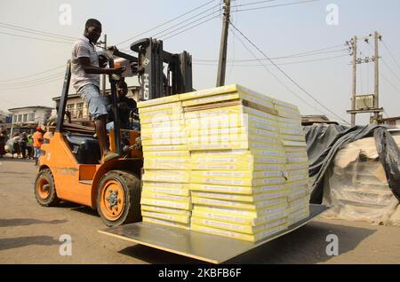 Ladenbesitzer retten auf dem beliebten Holzmarkt in Mushin, Lagos, am 25. Januar 2020 einige Überreste ihrer Habseligkeiten. Es wurden keine Verletzten gemeldet, und die Ursache des Feuers ist noch nicht bekannt. (Foto von Olukayode Jaiyeola/NurPhoto) Stockfoto