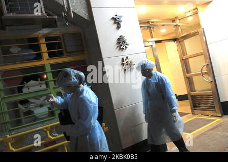 Beamte, die PSA tragen, stehen am Eingang des Heng Tai Hauses im Fu Heng Estate, wo zwei Personen, die in diesem Gebäude leben, am 14. März 2020 in Hongkong, China, mit dem Covid-19 diagnostiziert wurden. Das Coronavirus oder Covid-19, das aus Wuhan China stammt, hat über 120.000 infiziert und 4617 Menschen weltweit getötet. Die Weltgesundheitsorganisation (WHO) hat den Covid-19 zu einem Ausbruch erklärt, die Regierung hat beschlossen, einige Bewohner im Heng Tai House zu evakuieren, nachdem zwei Bewohner einen positiven Covid-19-Test durchgeführt hatten. (Foto von Vernon Yuen/NurPhoto) Stockfoto